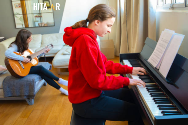 Beginner playing an acoustic guitar, learning basic chords and strumming patterns.