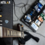 Guitarist using a setup with a guitar effect that mimics a voice for expressive tones
