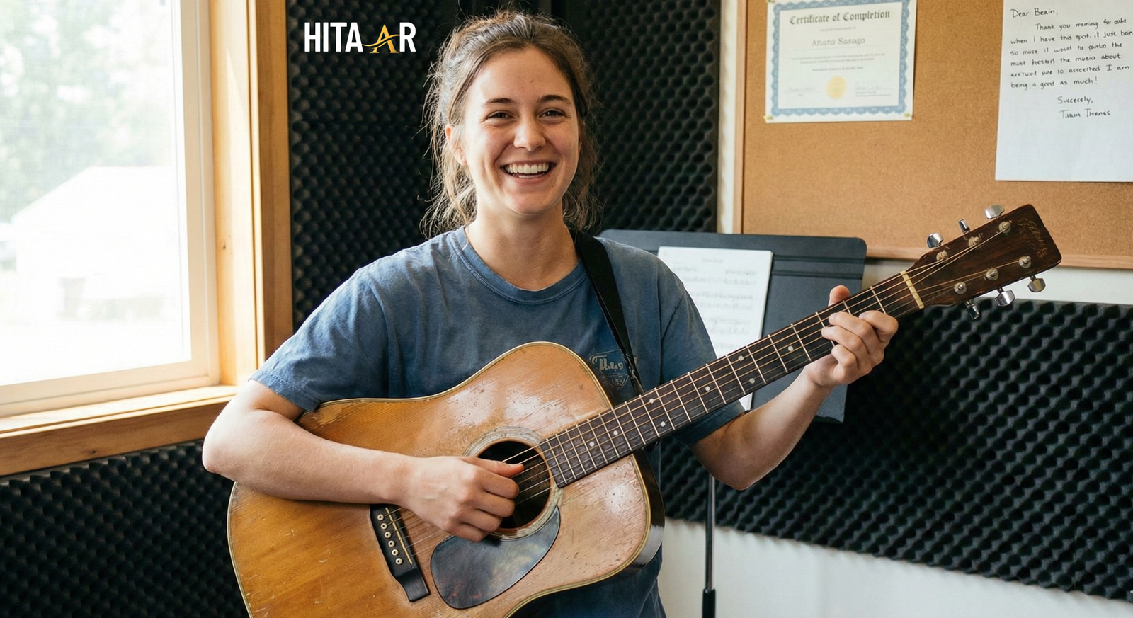 free guitar lessons for mental health, Smiling person holding their guitar proudly after completing a lesson.