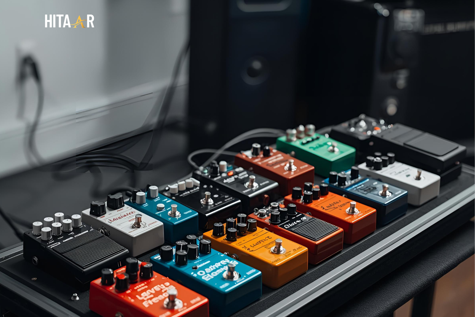 Professional guitarist arranging pedals on a large pedalboard